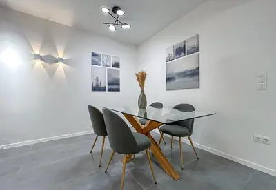 a dining room with a glass table and chairs at LIV - Modern Comfort Oasis in Pagrati in Athens