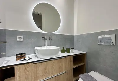 a bathroom with a sink and a mirror at LIV - Modern Comfort Oasis in Pagrati in Athens