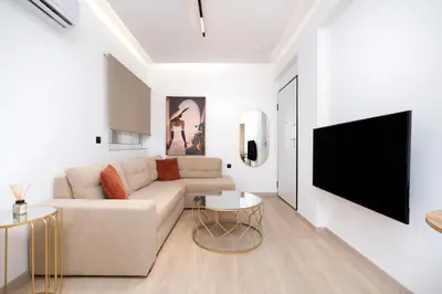 a living room with a couch and a flat screen tv at Stylish Apartment in Athens Riviera with Outdoor Patio in Athens
