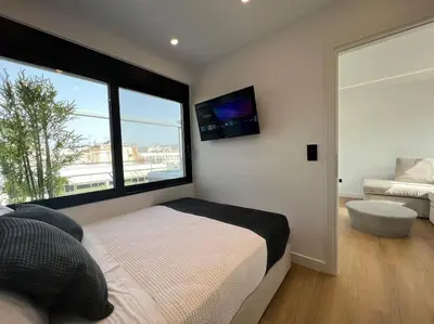 a bedroom with a bed and a large window at BlueMotion - PortDome in Piraeus