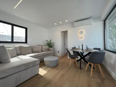 a living room with a couch and a table at BlueMotion - PortDome in Piraeus