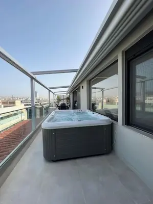 a hot tub on the balcony of a building at BlueMotion - PortDome in Piraeus