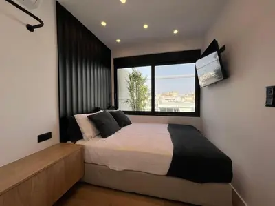 a bedroom with a large bed with a large window at BlueMotion - PortDome in Piraeus