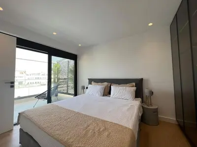 a bedroom with a large bed and a large window at BlueMotion - PortDome in Piraeus