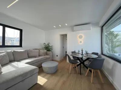 a living room with a couch and a table at BlueMotion - PortDome in Piraeus