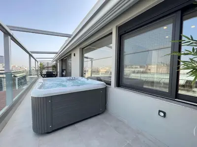 a hot tub on the balcony of a house at BlueMotion - PortDome in Piraeus