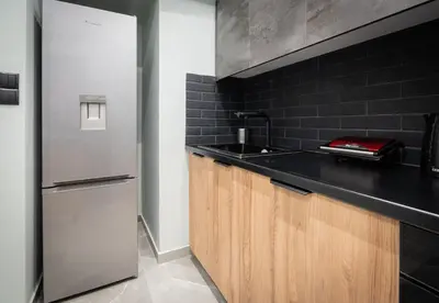 a kitchen with a sink and a refrigerator at LIV - Comfortable Designer Apt in Lycabettus in Athens