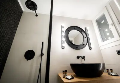 a bathroom with a black sink and a mirror at LIV - Comfortable Designer Apt in Lycabettus in Athens