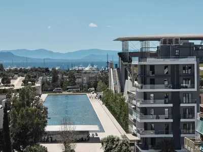 a view of a building and a swimming pool at AVA Hotel & Residences Athens Riviera in Athens