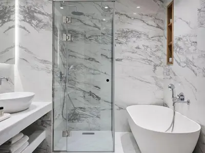 a bathroom with a glass shower and a sink at AVA Hotel & Residences Athens Riviera in Athens