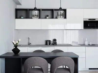 a kitchen with a black table and chairs at AVA Hotel & Residences Athens Riviera in Athens