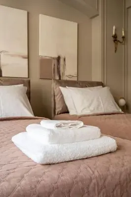 a stack of towels on top of a bed at Urban Elegance in Kolonaki in Athens