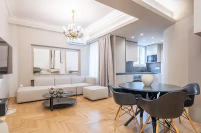 a living room with a black table and chairs at Urban Elegance in Kolonaki in Athens