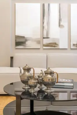 a living room with a table with two vases on it at Urban Elegance in Kolonaki in Athens