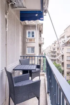 a balcony with two chairs and a table on a building at Urban Elegance in Kolonaki in Athens