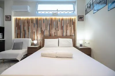 a bedroom with a large white bed and a window at Cozy Studio at Vyronas for 2 pers by MPS in Athens