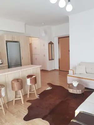 a living room with a couch and a table and chairs at Urban by the Sea in Piraeus