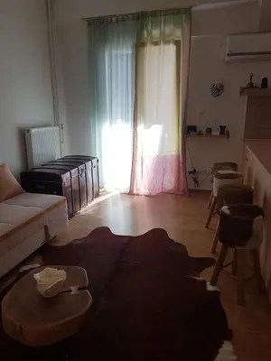 a living room with a couch and a table at Urban by the Sea in Piraeus