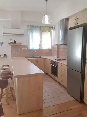 a kitchen with a refrigerator and a counter top at Urban by the Sea in Piraeus