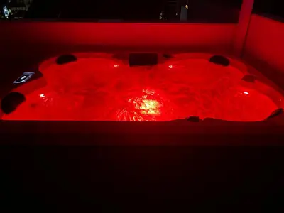 a red tub filled with red light in a dark room at Glyf Seaview Penthouse by Taurus in Athens