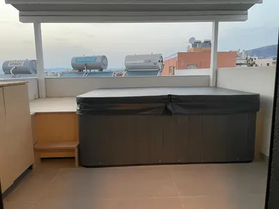 a balcony with a table and a large window at Glyf Seaview Penthouse by Taurus in Athens