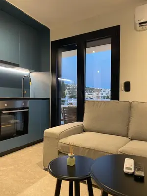a living room with a couch and a table at Glyf Seaview Penthouse by Taurus in Athens
