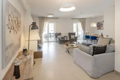 a living room with a couch and a table at Holiday Maisonette in Varkiza by GHH in Vari
