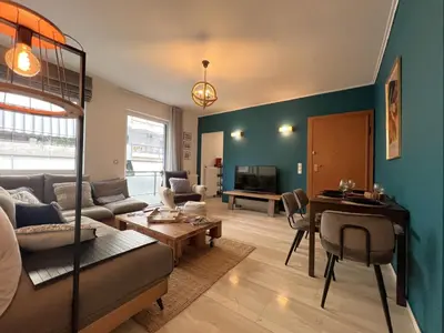 a living room with a couch and a table at Stylish Apt in Paleo Faliro 300m from the beach in Athens