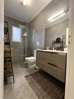 a bathroom with a toilet and a shower and a sink at Stylish Apt in Paleo Faliro 300m from the beach in Athens