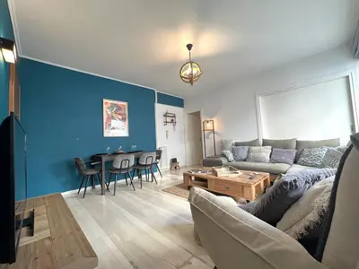 a living room with a couch and a table at Stylish Apt in Paleo Faliro 300m from the beach in Athens