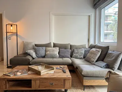 a living room with a couch and a coffee table at Stylish Apt in Paleo Faliro 300m from the beach in Athens
