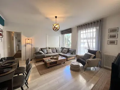 a living room with a couch and a table at Stylish Apt in Paleo Faliro 300m from the beach in Athens