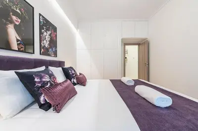 a bedroom with a large white bed with pillows at Cozy Home In Athens in Athens