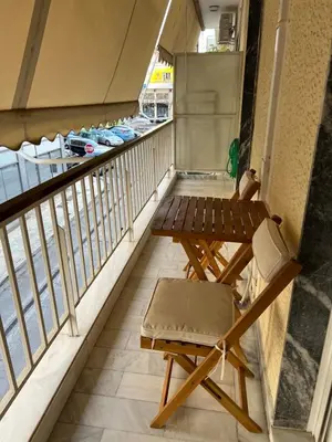 a balcony with a table and a bench at Cozy Home In Athens in Athens