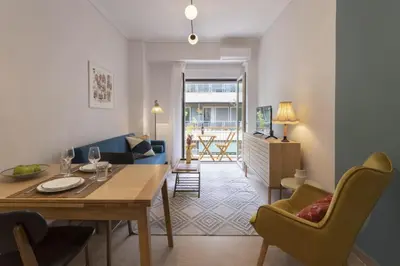 a dining room and living room with a table and chairs at SpyrouTrikoupi36-Cozy 1BDR Apartment near Archaeol in Athens