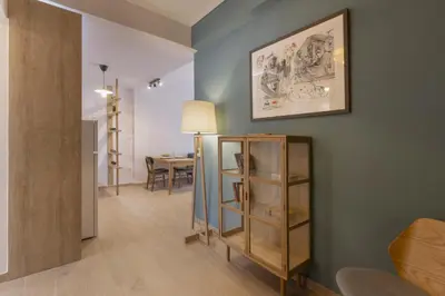 a living room with a table and a picture on the wall at SpyrouTrikoupi36-Cozy 1BDR Apartment near Archaeol in Athens