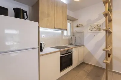 a kitchen with a refrigerator and a sink at SpyrouTrikoupi36-Cozy 1BDR Apartment near Archaeol in Athens