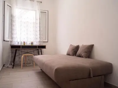 a bedroom with a bed and a table and a window at Athens Hill of Harmony in Athens