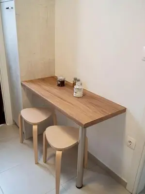 a wooden table with two stools and a table with two cups at Athens Hill of Harmony in Athens
