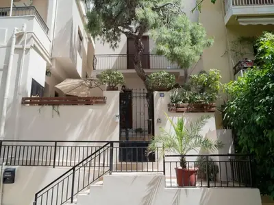 a building with a staircase with potted plants at Athens Hill of Harmony in Athens