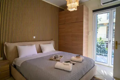 a bedroom with a large bed with two towels on it at Salty 2bed Bliss and Comfort in Athens