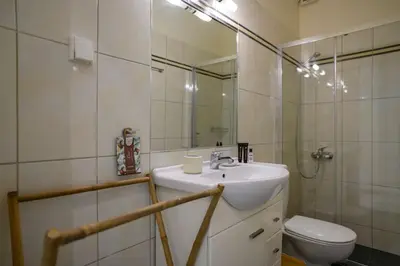 a bathroom with a sink and a toilet and a mirror at Salty 2bed Bliss and Comfort in Athens