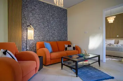 a living room with an orange couch and a table at Salty 2bed Bliss and Comfort in Athens