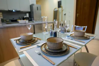 a table with plates and wine glasses on it at Salty 2bed Bliss and Comfort in Athens