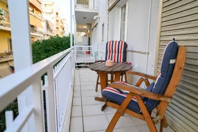 a patio with two chairs and a table on a balcony at Salty 2bed Bliss and Comfort in Athens