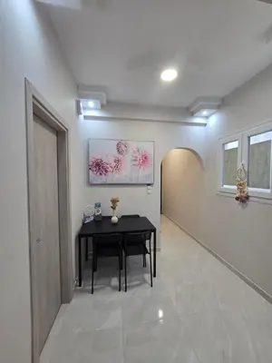 a hallway with a black table in a room at Cozzy double bedroom Apartment in Athens