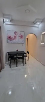 a dining room with a table and a bench at Cozzy double bedroom Apartment in Athens