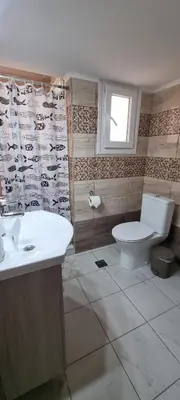 a bathroom with a toilet and a sink at Cozzy double bedroom Apartment in Athens