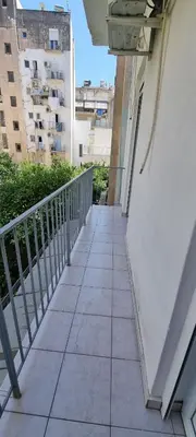 a walkway leading to a balcony in a building at Cozzy double bedroom Apartment in Athens