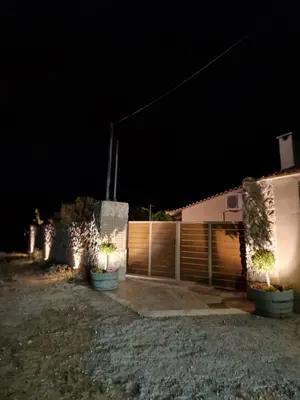 a house at night with some plants in pots at St'Georges garden house in Palaiá Fókaia